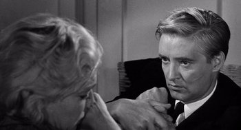 Movie still from “Ship of Fools” (1965), directed by Stanley Kramer – An older woman touching the ear of an older man; Close Up shot, Over the shoulder angle