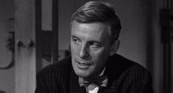 Movie still from “Ship of Fools” (1965), directed by Stanley Kramer – Black and white photograph of a man wearing a bow tie; Close Up shot, Over the shoulder angle