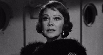 Movie still from “Ship of Fools” (1965), directed by Stanley Kramer – An old photo of a woman in a fur coat looking to her left; Close Up shot, Over the shoulder angle