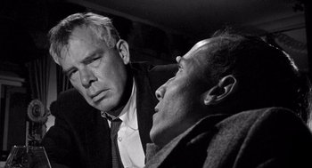 Movie still from “Ship of Fools” (1965), directed by Stanley Kramer – A man and a man sitting next to each other in a car; Close Up shot, Over the shoulder angle