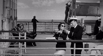 Movie still from “Ship of Fools” (1965), directed by Stanley Kramer – A man and a woman on a boat in the ocean; Medium shot, High angle