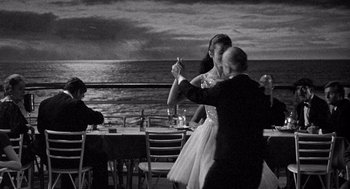 Movie still from “Ship of Fools” (1965), directed by Stanley Kramer – A man and a woman dancing at a table; Wide shot, Low angle