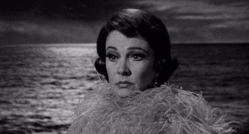 Movie still from “Ship of Fools” (1965), directed by Stanley Kramer – An old photo of an older woman in a black and white photo; Close Up shot, Low angle