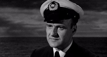 Movie still from “Ship of Fools” (1965), directed by Stanley Kramer – A man wearing a hat and a tie; Close Up shot, Low angle