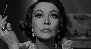 Movie still from “Ship of Fools” (1965), directed by Stanley Kramer – An old photo of an old woman with pearls in her hair; Close Up shot, Low angle