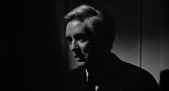 Movie still from “Ship of Fools” (1965), directed by Stanley Kramer – A black and white photo of a man in a suit; Close Up shot, Low angle