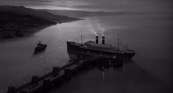 Movie still from “Ship of Fools” (1965), directed by Stanley Kramer – A large ship in a body of water; Extreme Wide shot, High angle