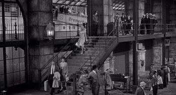 Movie still from “Ship of Fools” (1965), directed by Stanley Kramer – A black and white photo of people walking down stairs; Extreme Wide shot, High angle