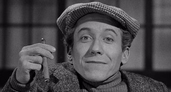 Movie still from “Ship of Fools” (1965), directed by Stanley Kramer – An old photo of a man holding a cigarette in his hand; Close Up shot, High angle