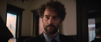 A person wearing a suit and tie