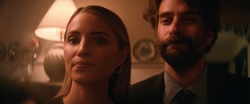 A man and a woman standing next to each other in a room