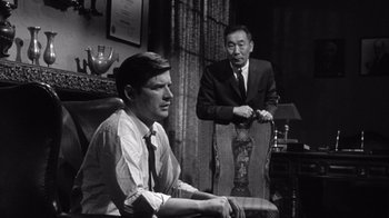 Movie still from “Shock Corridor” (1963), directed by Samuel Fuller – Two men sitting in a living room next to each other; Medium shot, Over the shoulder angle