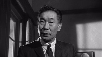 Movie still from “Shock Corridor” (1963), directed by Samuel Fuller – An older man wearing a suit and a tie; Close Up shot, Low angle