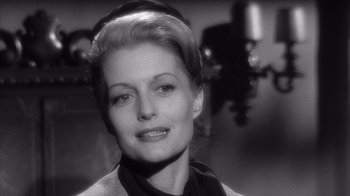 Movie still from “Shock Corridor” (1963), directed by Samuel Fuller – A black - and - white photo of a woman in a black shirt; Close Up shot, Low angle