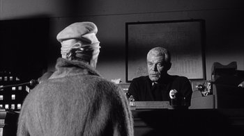 Movie still from “Shock Corridor” (1963), directed by Samuel Fuller – An older man looking at himself in the mirror; Medium shot, Over the shoulder angle
