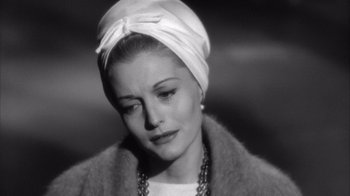 Movie still from “Shock Corridor” (1963), directed by Samuel Fuller – A black and white photo of a woman wearing a turban; Close Up shot, Over the shoulder angle