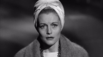 Movie still from “Shock Corridor” (1963), directed by Samuel Fuller – A black and white photo of a woman wearing a turban; Close Up shot, High angle