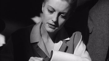 Movie still from “Shock Corridor” (1963), directed by Samuel Fuller – A black - and - white photo of a woman looking down; Close Up shot, Low angle