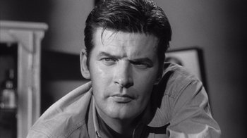 Movie still from “Shock Corridor” (1963), directed by Samuel Fuller – Black and white photograph of a man with a serious look; Close Up shot, Low angle