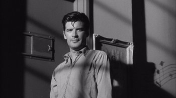 Movie still from “Shock Corridor” (1963), directed by Samuel Fuller – Black and white photograph of a man standing in front of an open door; Close Up shot, Over the shoulder angle
