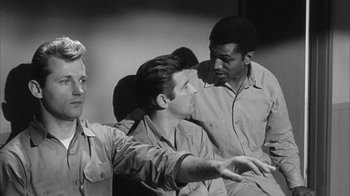 Movie still from “Shock Corridor” (1963), directed by Samuel Fuller – A group of men sitting next to each other in a room; Medium shot, High angle