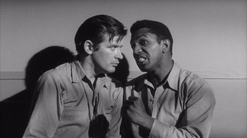Movie still from “Shock Corridor” (1963), directed by Samuel Fuller – A black and white photo of two men talking to each other; Close Up shot, Low angle