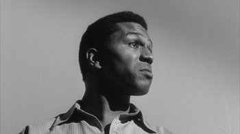 Movie still from “Shock Corridor” (1963), directed by Samuel Fuller – A black and white photo of a man looking up; Close Up shot, Low angle