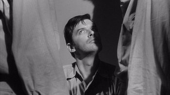 Movie still from “Shock Corridor” (1963), directed by Samuel Fuller – Black and white photograph of a man looking up; Close Up shot, Over the shoulder angle