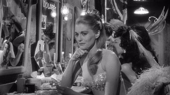 Movie still from “Shock Corridor” (1963), directed by Samuel Fuller – A black and white photo of a woman sitting at a table; Close Up shot, Over the shoulder angle