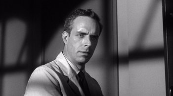 Movie still from “Shock Corridor” (1963), directed by Samuel Fuller – Black and white photograph of a man wearing a tie; Close Up shot, Low angle