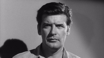 Movie still from “Shock Corridor” (1963), directed by Samuel Fuller – Black and white photograph of a man with a mustache; Close Up shot, Low angle