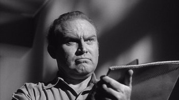 Movie still from “Shock Corridor” (1963), directed by Samuel Fuller – An older man is holding something in his hand; Close Up shot, Low angle