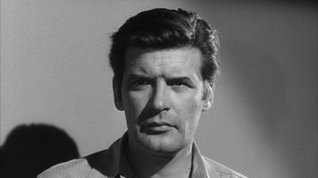 Movie still from “Shock Corridor” (1963), directed by Samuel Fuller – Black and white photograph of a man with a mustache; Close Up shot, Low angle