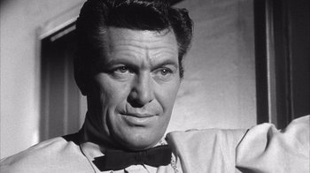 Movie still from “Shock Corridor” (1963), directed by Samuel Fuller – Black and white photograph of a man wearing a bow tie; Close Up shot, Low angle