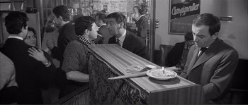 Movie still from “Shoot the Piano Player” (1960), directed by François Truffaut – A man and a woman sitting at a counter; Medium shot, Over the shoulder angle