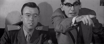 Movie still from “Shoot the Piano Player” (1960), directed by François Truffaut – Two men are smoking and one has a knife in his hand; Close Up shot, Over the shoulder angle