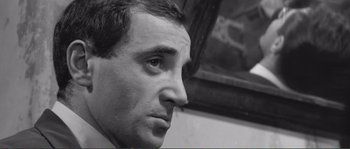 Movie still from “Shoot the Piano Player” (1960), directed by François Truffaut – Black and white photograph of a man looking to his left; Close Up shot, Over the shoulder angle