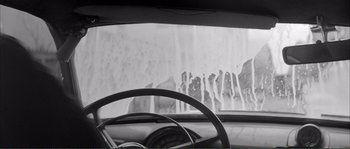 Movie still from “Shoot the Piano Player” (1960), directed by François Truffaut – A view from inside of a car of a waterfall; Medium shot, Low angle