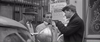 Movie still from “Shoot the Piano Player” (1960), directed by François Truffaut – An old black and white photo of a man getting his hair cut; Medium shot, Over the shoulder angle