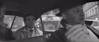 Movie still from “Shoot the Piano Player” (1960), directed by François Truffaut – Two men in a car looking at each other; Close Up shot, Over the shoulder angle