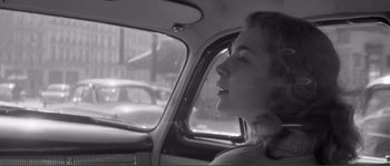 Movie still from “Shoot the Piano Player” (1960), directed by François Truffaut – A young girl sitting in the passenger seat of a car; Close Up shot, Low angle