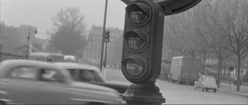Movie still from “Shoot the Piano Player” (1960), directed by François Truffaut – A traffic light sitting on the side of a road; Medium shot, Low angle