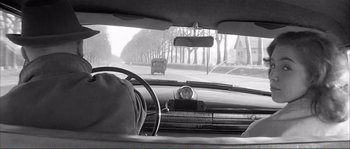 Movie still from “Shoot the Piano Player” (1960), directed by François Truffaut – A black and white photo of a car's dashboard; Medium shot, Low angle