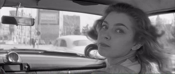 Movie still from “Shoot the Piano Player” (1960), directed by François Truffaut – A black - and - white photo of a woman in the backseat of a car; Close Up shot, Low angle