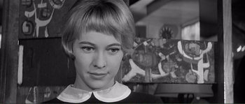 Movie still from “Shoot the Piano Player” (1960), directed by François Truffaut – A black - and - white photo of a young woman with short blonde hair; Close Up shot, Low angle