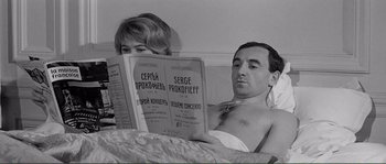 Movie still from “Shoot the Piano Player” (1960), directed by François Truffaut – A man and a woman reading a newspaper in bed; Medium shot, High angle