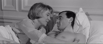 Movie still from “Shoot the Piano Player” (1960), directed by François Truffaut – A man and a woman are smiling and looking at each other; Close Up shot, High angle