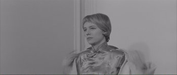 Movie still from “Shoot the Piano Player” (1960), directed by François Truffaut – Black and white photograph of a woman in a chinese dress; Close Up shot, Low angle