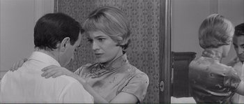 Movie still from “Shoot the Piano Player” (1960), directed by François Truffaut – A woman in a satin top is looking at a man in a white shirt; Close Up shot, Over the shoulder angle