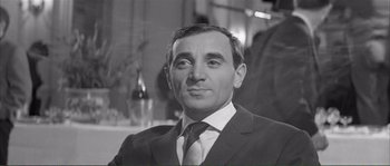Movie still from “Shoot the Piano Player” (1960), directed by François Truffaut – Black and white photograph of a man wearing a suit and tie; Close Up shot, Low angle